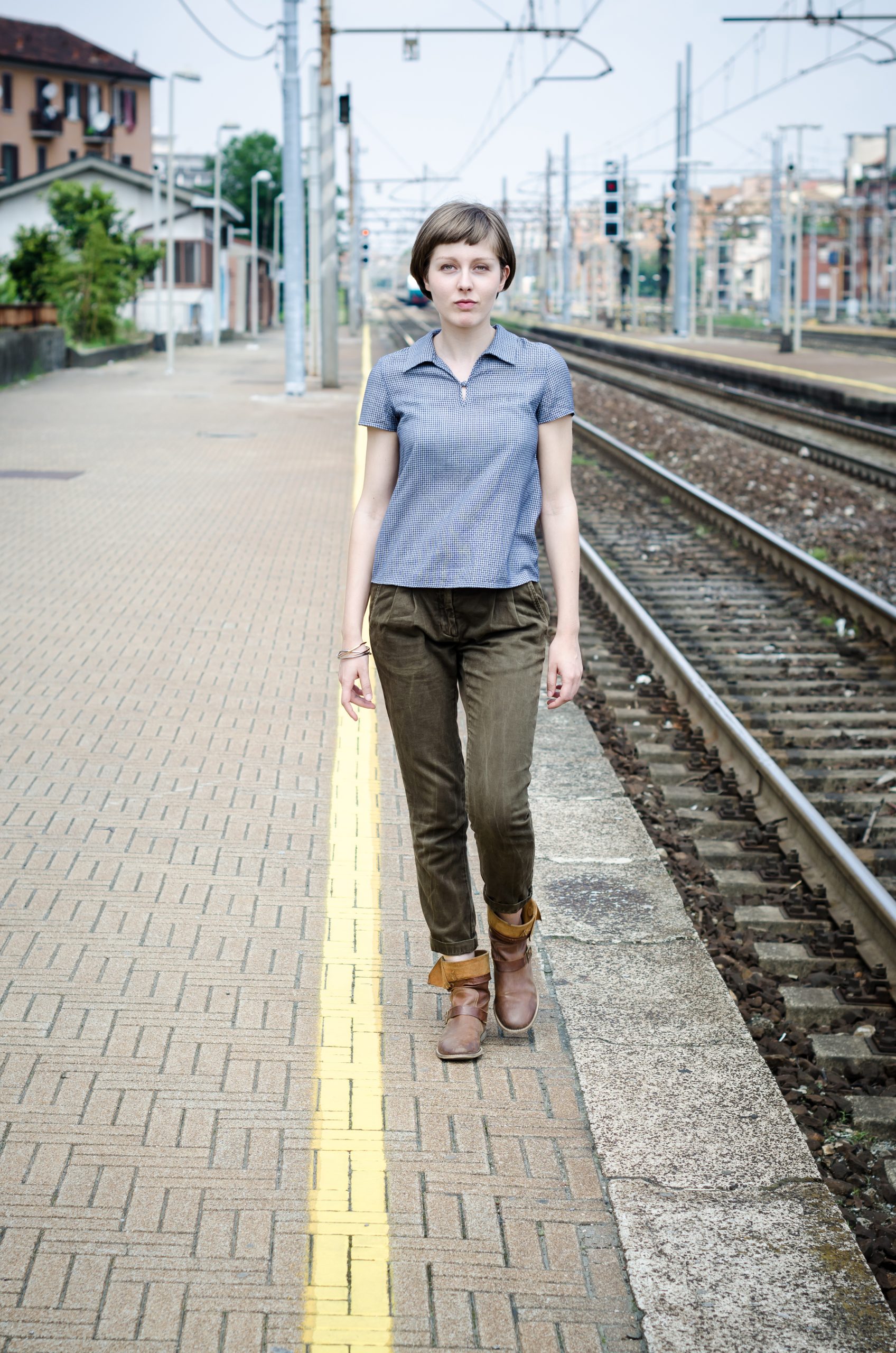 graphicstock young beautiful hipster woman walking in a railway station reGCfdYWgW scaled