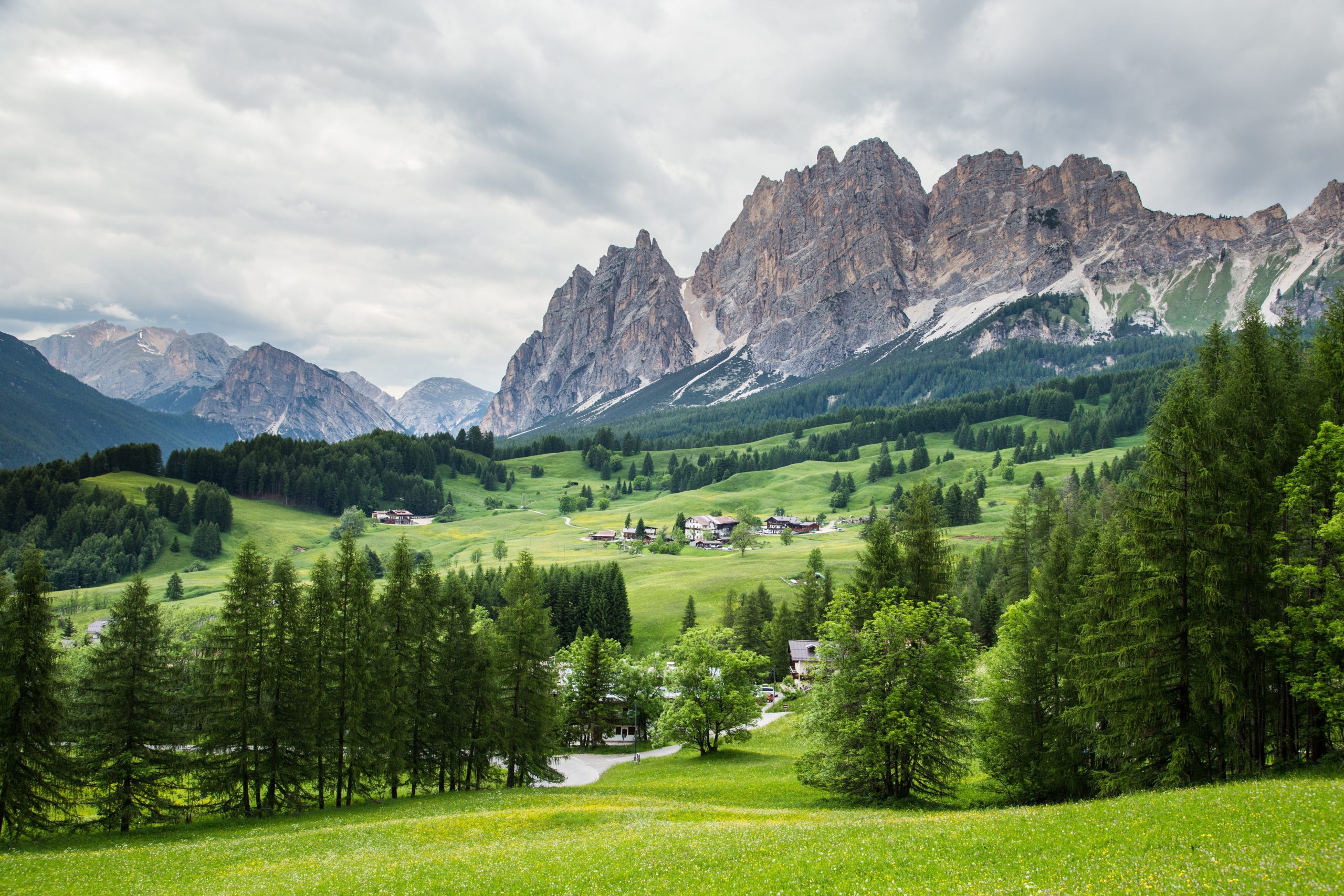 amazing view on cristallo mountains with alpine village on sunny summer day the dolomites mountains italy BvVTNJO2fg scaled