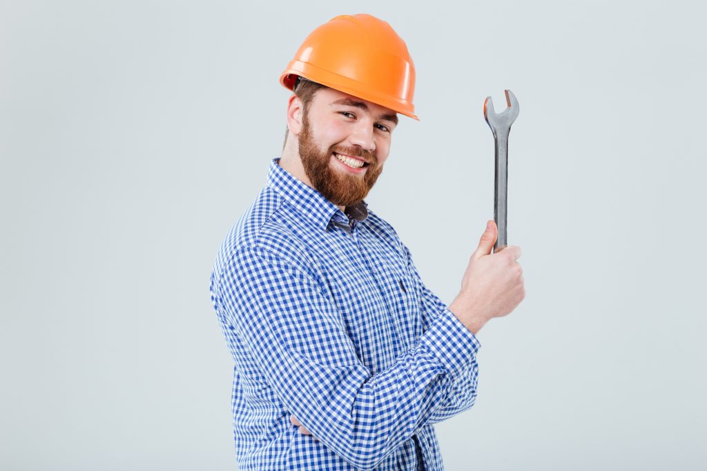 graphicstock portrait of smiling bearded young man in helmet with wrench over white background HuWuPCp8nl 2