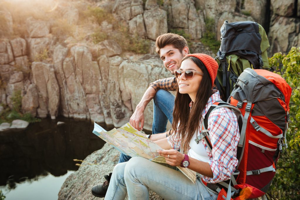 graphicstock traveler couple with map near the canyon sittong on slope HufrUDHI3x