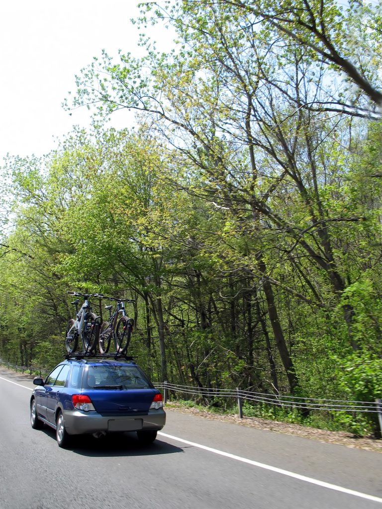 a car carrying a couple of mountain bikes on its way to its destination rFReT1F0ro