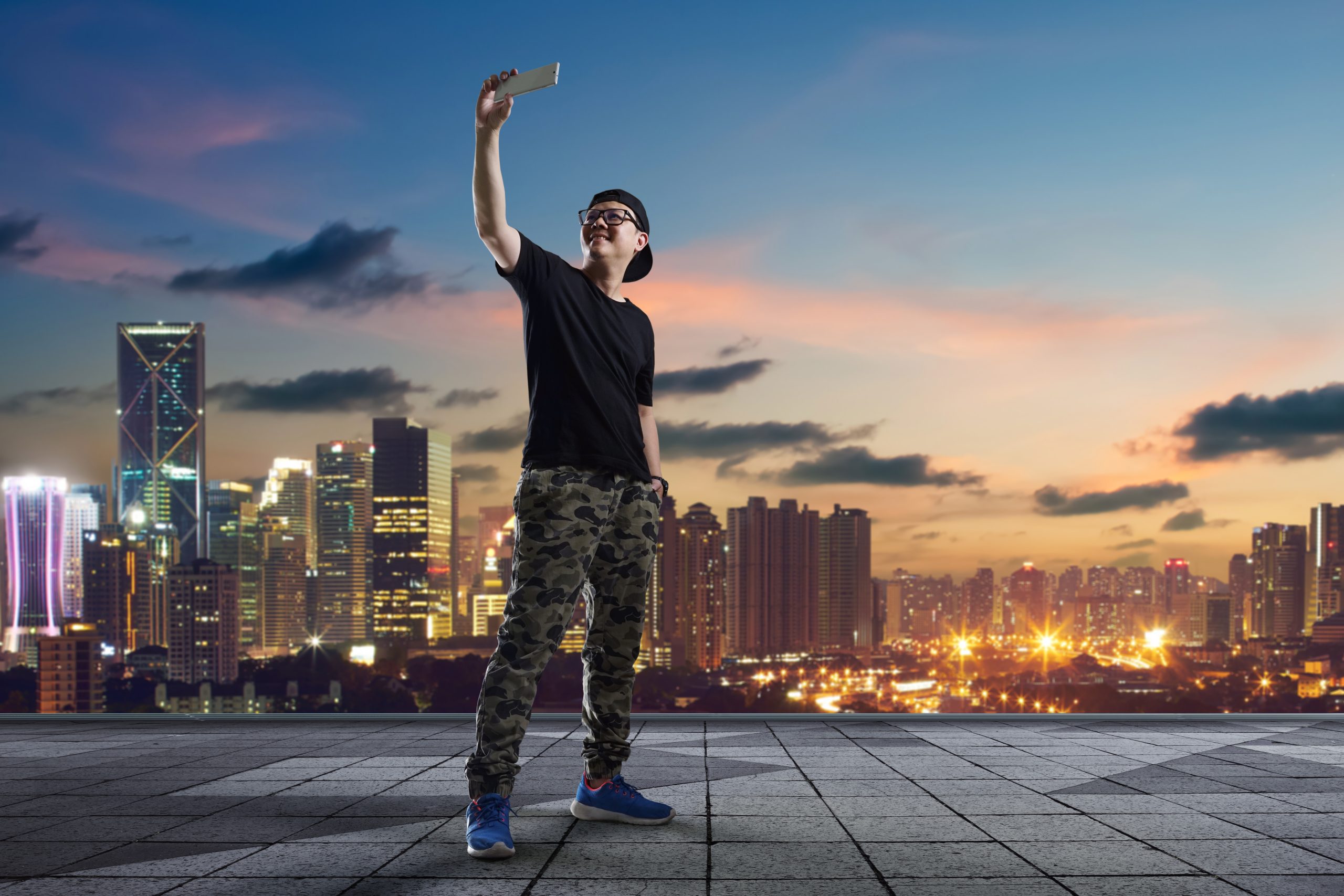 graphicstock man taking selfie at rooftop on city skyline background BOijqiPgjg scaled